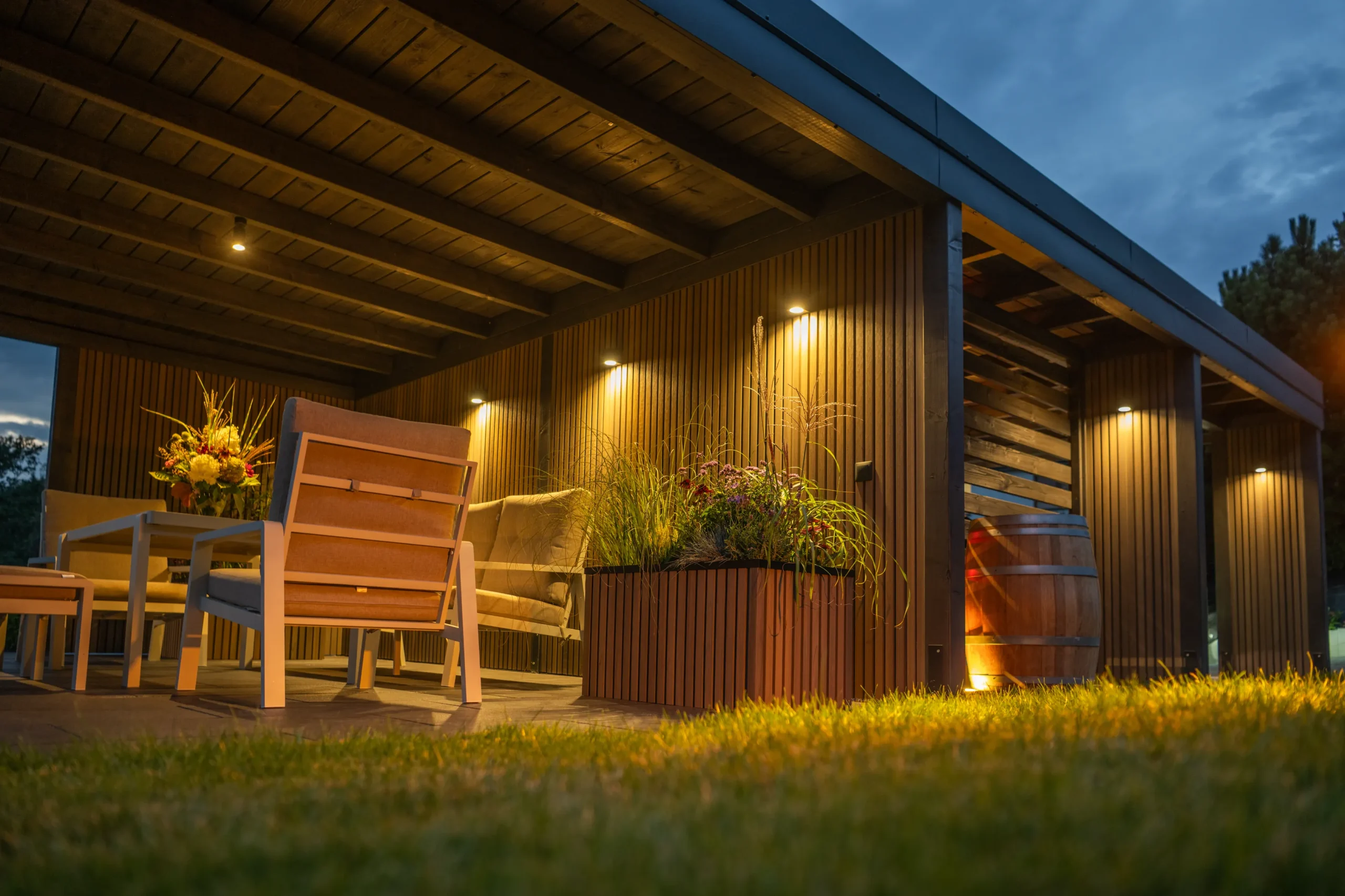 A cozy outdoor seating with wooden furniture and good lighting.